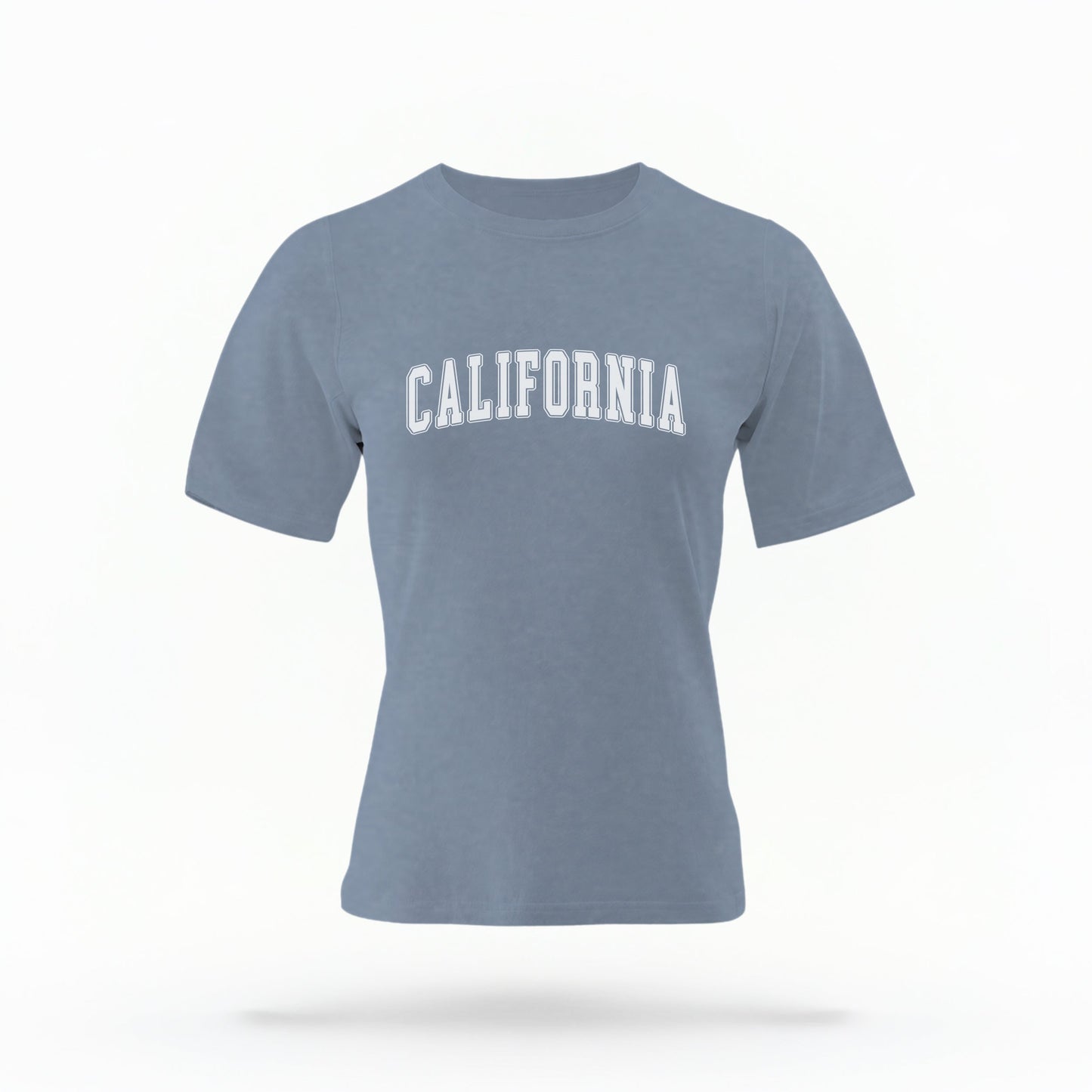 The Blue Jean California Varsity Comfort Colors T-shirt lays flat on a white background. The California Varsity graphic is in bold White in a Varsity style.