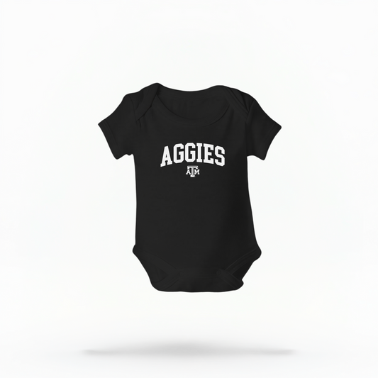 The Black Infant Unisex Texas A&M Aggies Collegiate Bodysuit lays flat on a white background. The ﻿Texas A&M Aggies Collegiate﻿ graphic is in bold White in a Varsity style.