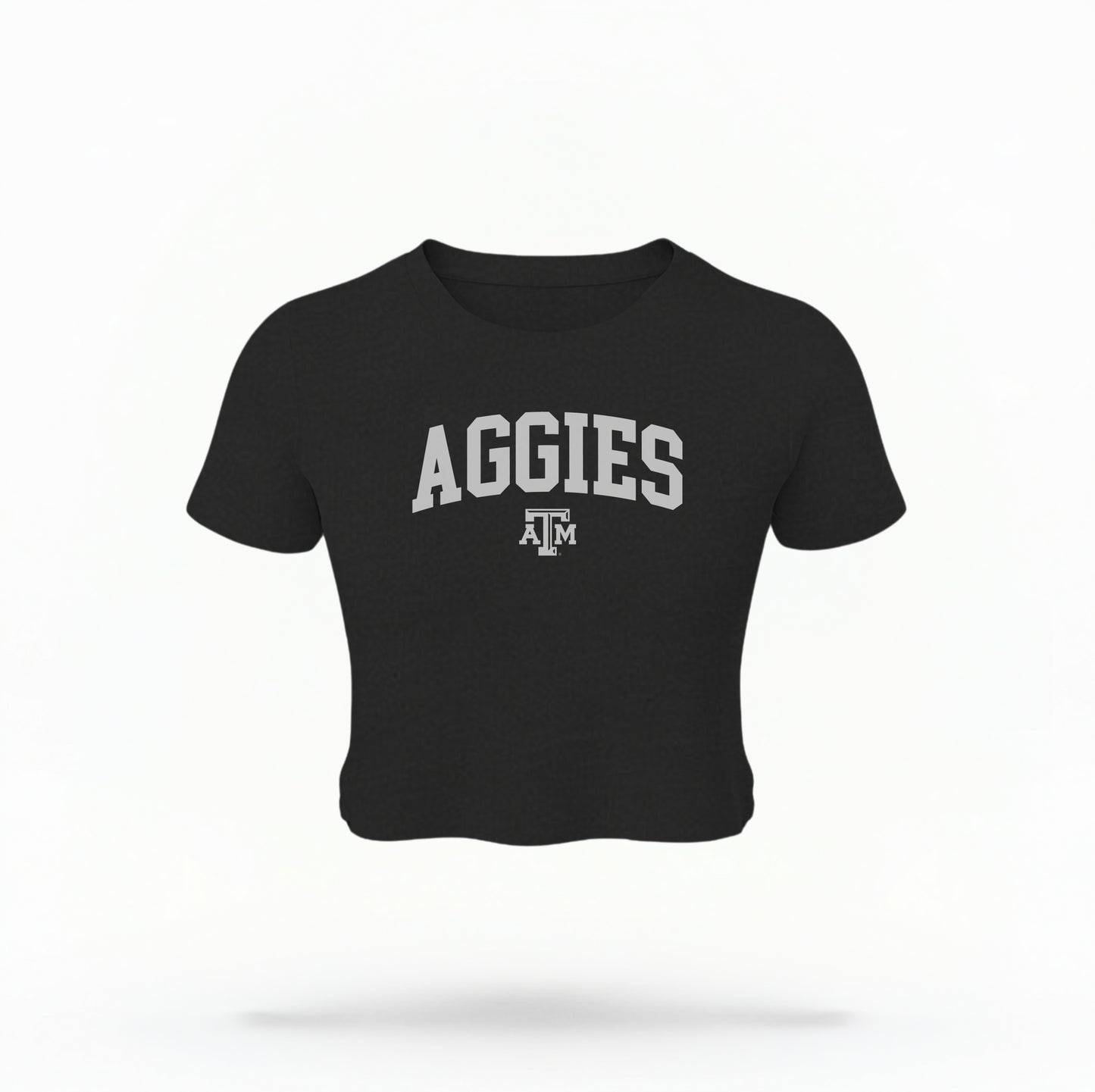 The Black Texas A&M Aggies Collegiate Crop Top lays flat on a white background. The ﻿Texas A&M Aggies Collegiate﻿ graphic is in bold white in a Varsity style.