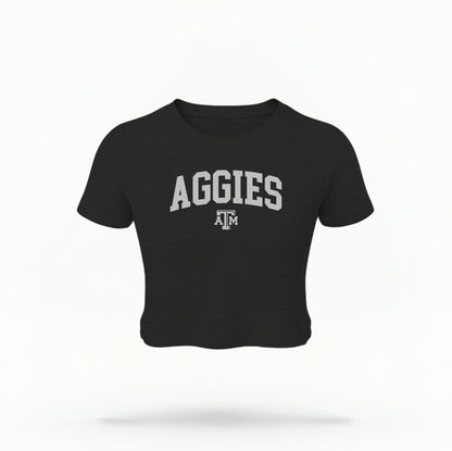 The Black Texas A&M Aggies Collegiate Crop Top lays flat on a white background. The ﻿Texas A&M Aggies Collegiate﻿ graphic is in bold white in a Varsity style.