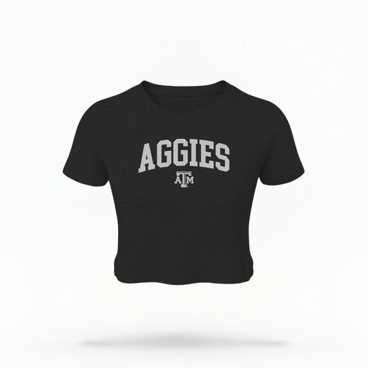 The Black Texas A&M Aggies Collegiate Crop Top lays flat on a white background. The ﻿Texas A&M Aggies Collegiate﻿ graphic is in bold white in a Varsity style.