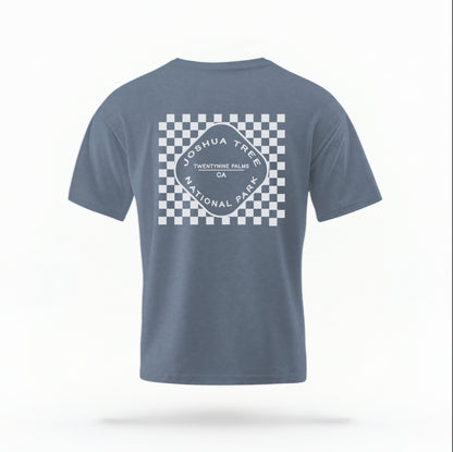The Blue Jean Joshua Tree Retro Checkered Comfort Colors T-shirt lays flat on a white background. The ﻿Joshua Tree Retro Checkered﻿ graphic is in bold White in a Retro style.