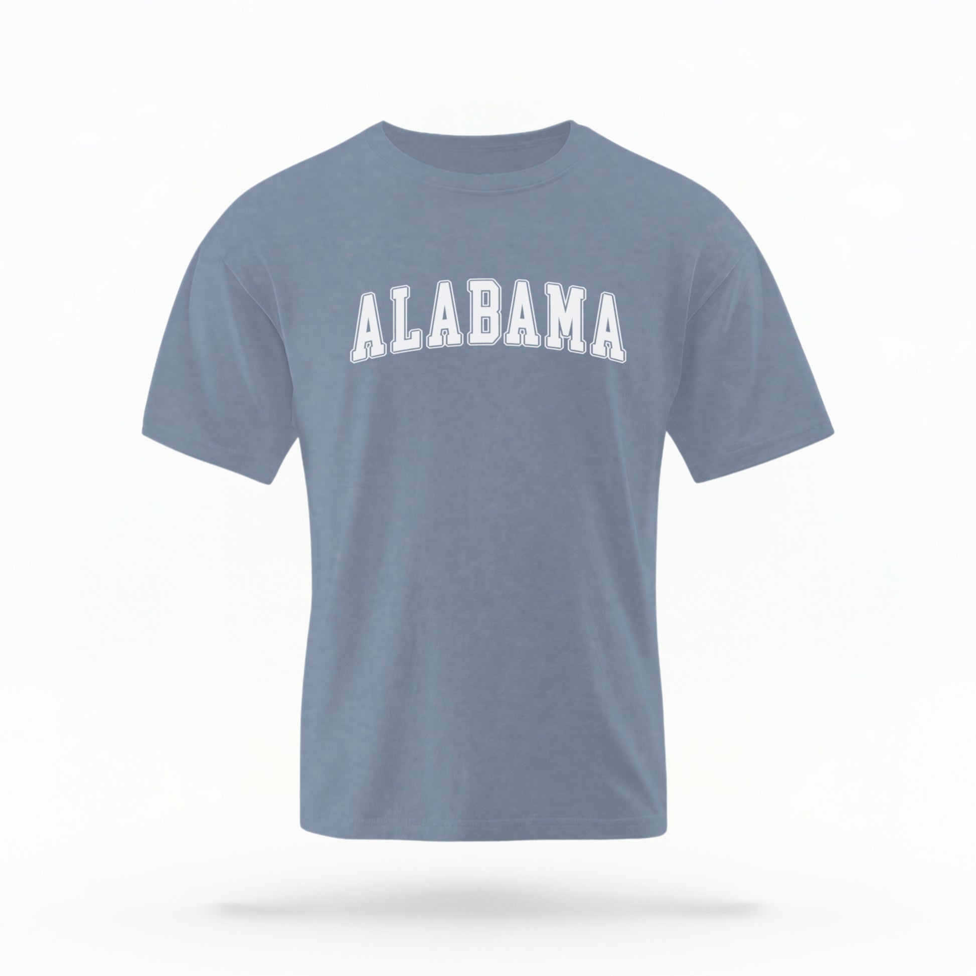 The Blue Jeans Unisex Alabama Varsity Comfort Colors T-shirt lays flat on a white background. The Alabama graphic is in bold white in a varsity offset style.