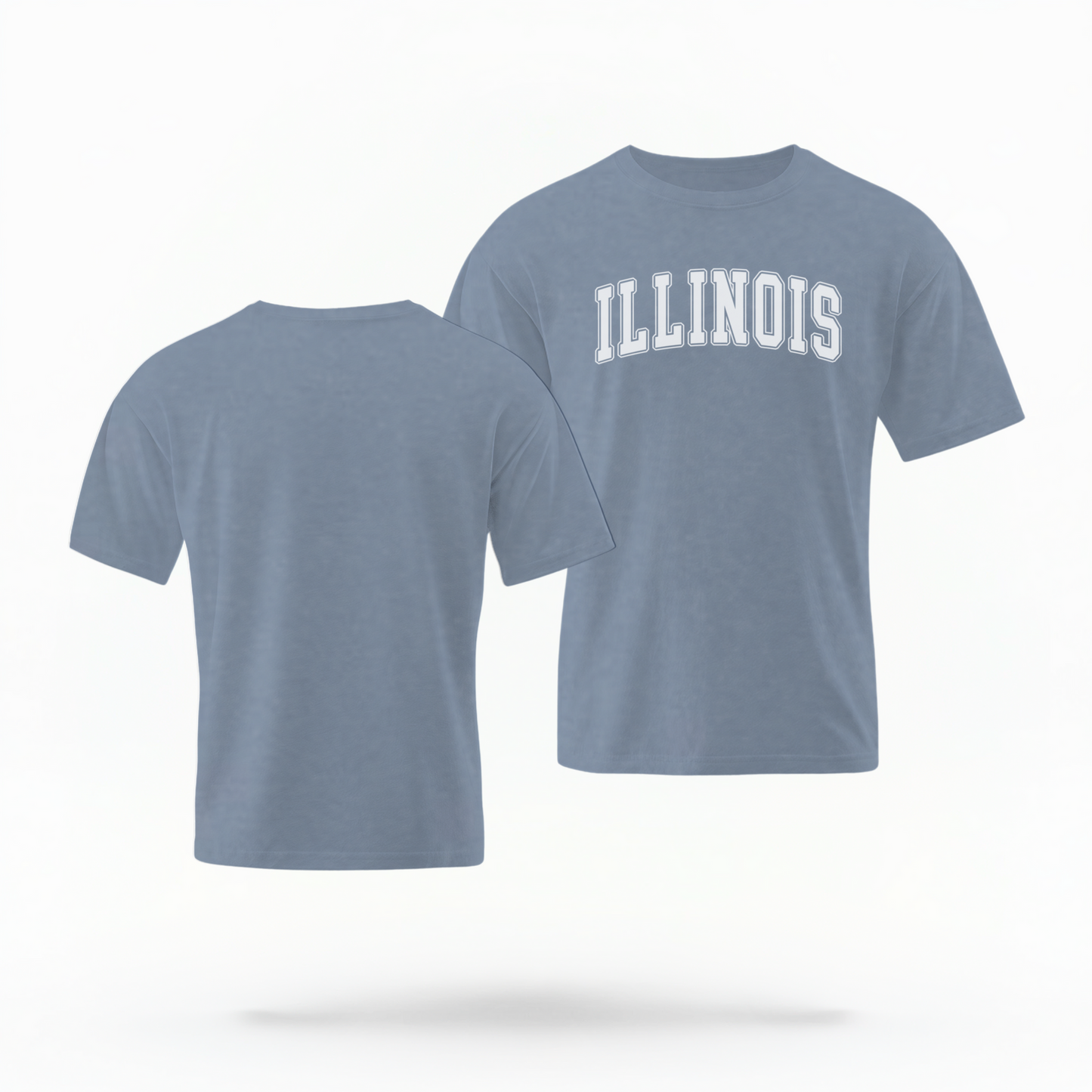 The Blue Jeans Unisex Illinois Varsity Comfort Colors T-shirt lays flat on a white background. The Illinois graphic is in bold white in a varsity offset style.
