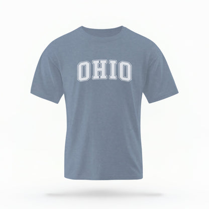 The Blue Jeans Unisex Ohio Varsity Comfort Colors T-shirt lays flat on a white background. The Ohio graphic is in bold white in a varsity offset style.