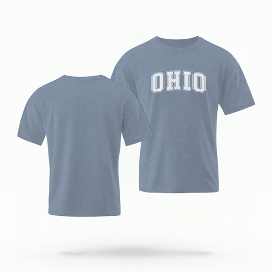 The Blue Jeans Unisex Ohio Varsity Comfort Colors T-shirt lays flat on a white background. The Ohio graphic is in bold white in a varsity offset style.