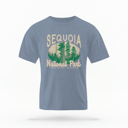 The Blue Jeans Adult Unisex Sequoia National Park Comfort Colors T-shirt lays flat on a white background. The ﻿Sequoia National Park﻿ graphic is in bold cream in a Rustic Park style.