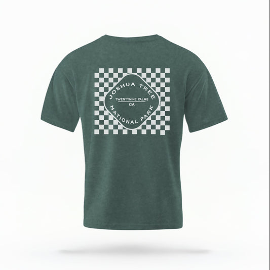 The Blue Spruce Joshua Tree Retro Checkered Comfort Colors T-shirt lays flat on a white background. The ﻿Joshua Tree Retro Checkered﻿ graphic is in bold White in a Retro style.