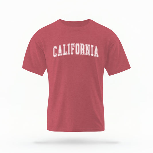 The Crimson California Varsity Comfort Colors T-shirt lays flat on a white background. The ﻿California Varsity﻿ graphic is in bold White in a Varsity style.