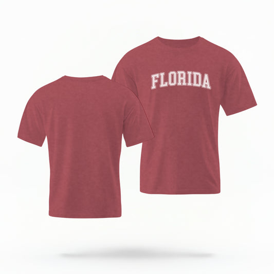 The crimson Adult Unisex Florida Varsity Comfort Colors T-shirt lays flat on a white background. The Florida graphic is in bold white in a varsity offset style.