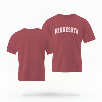 The Crimson Unisex Minnesota Varsity Comfort Colors T-shirt lays flat on a white background. The Minnesota graphic is in bold white in a varsity offset style.