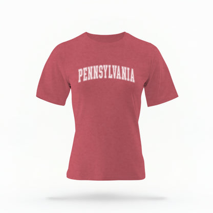 The Crimson Unisex Pennsylvania Varsity Comfort Colors T-shirt lays flat on a white background. The Pennsylvania graphic is in bold white in a varsity offset style.