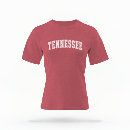 The Crimson Unisex Tennessee Varsity Comfort Colors T-shirt lays flat on a white background. The Tennessee graphic is in bold white in a varsity offset style.