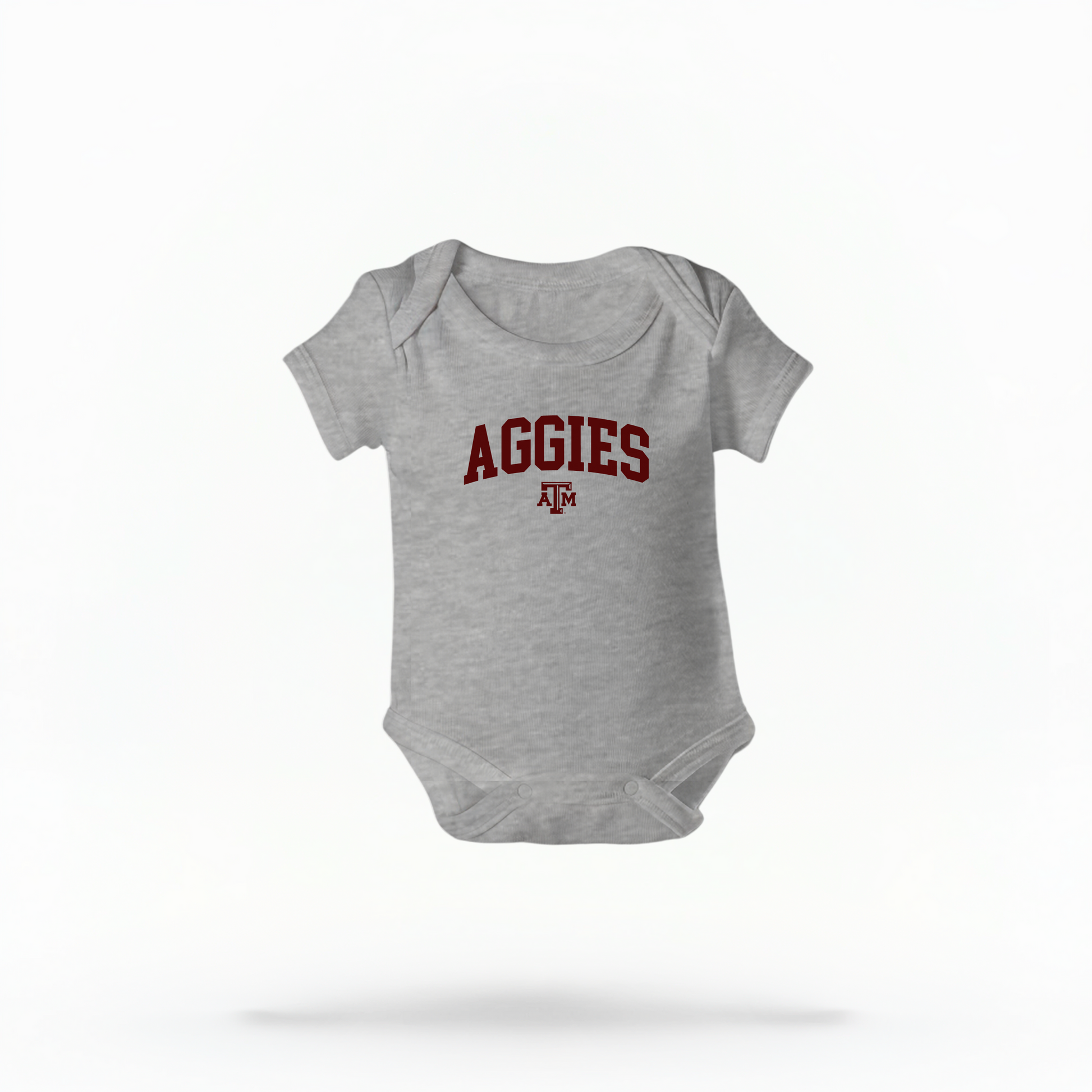 The Heather Infant Unisex Texas A&M Aggies Collegiate Bodysuit lays flat on a white background. The ﻿Texas A&M Aggies Collegiate﻿ graphic is in bold Maroon in a Varsity style.