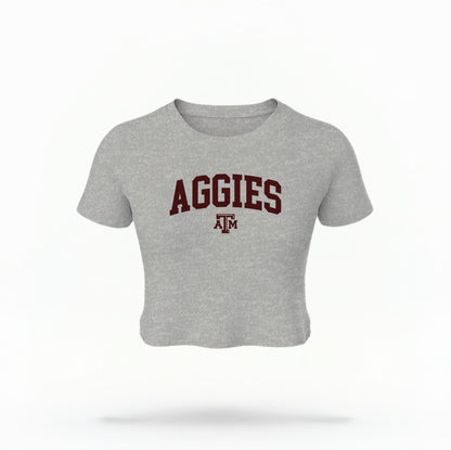 The Athletic Heather Texas A&M Aggies Collegiate Crop Top lays flat on a white background. The ﻿Texas A&M Aggies Collegiate﻿ graphic is in bold Maroon in a Varsity style.