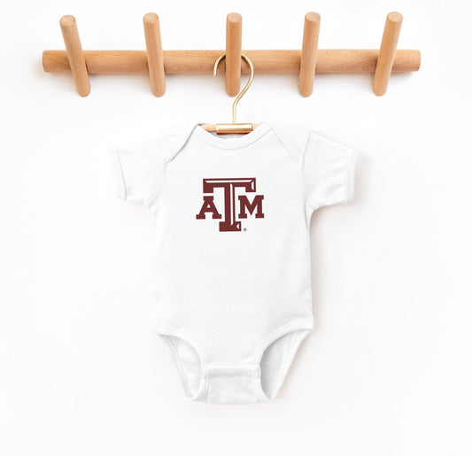 The White Infant Unisex Texas A&M Logo Bodysuit lays flat on a white background. The ﻿Texas A&M Logo﻿ graphic is in bold Maroon in a Varsity style.