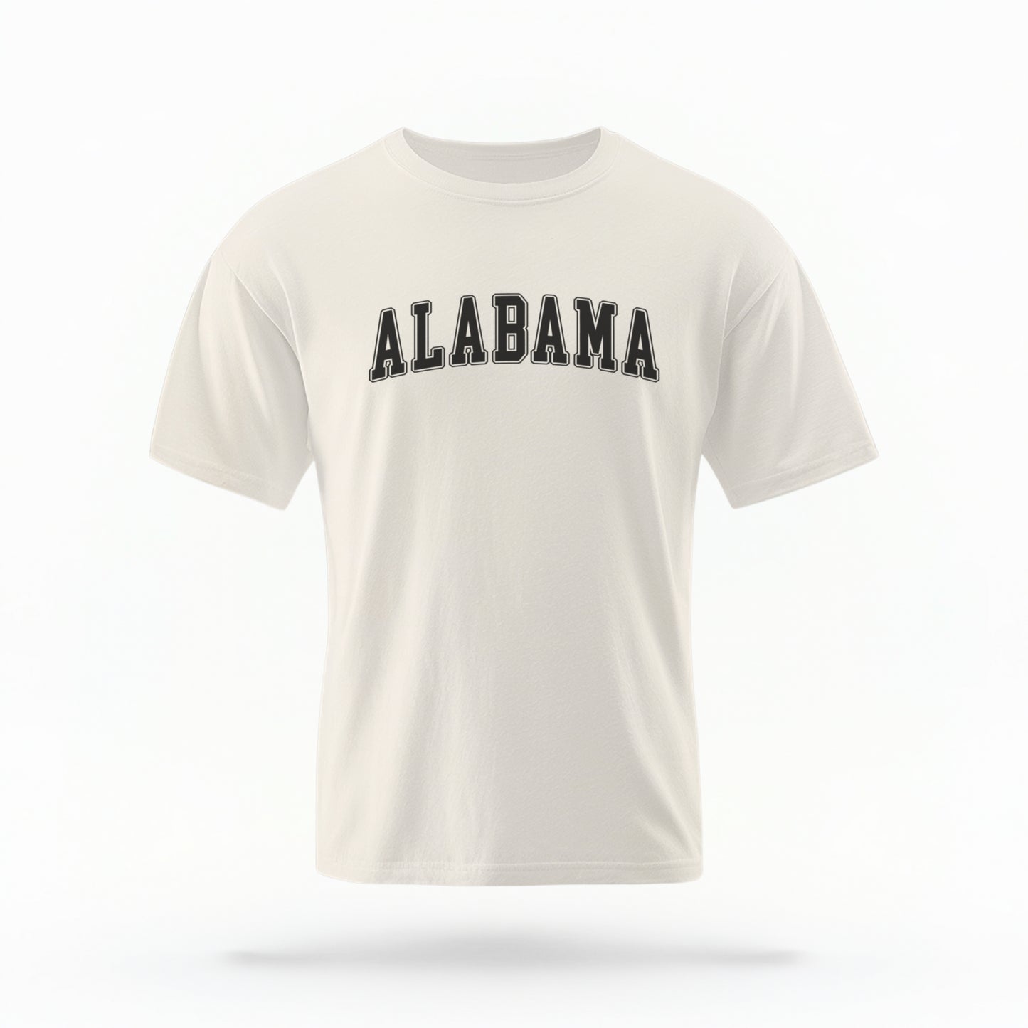 The ivory Unisex Alabama Varsity Comfort Colors T-shirt lays flat on a white background. The Alabama graphic is in bold black in a varsity offset style.