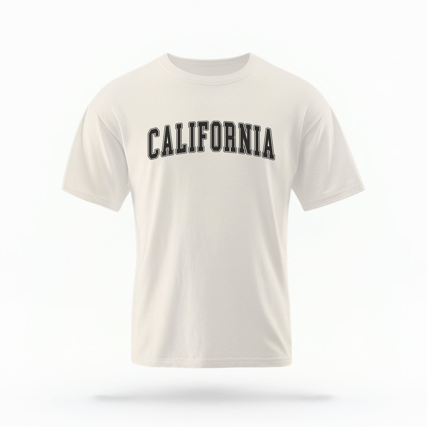 The Ivory California Varsity Comfort Colors T-shirt lays flat on a white background. The ﻿California Varsity﻿ graphic is in bold Black in a Varsity style.