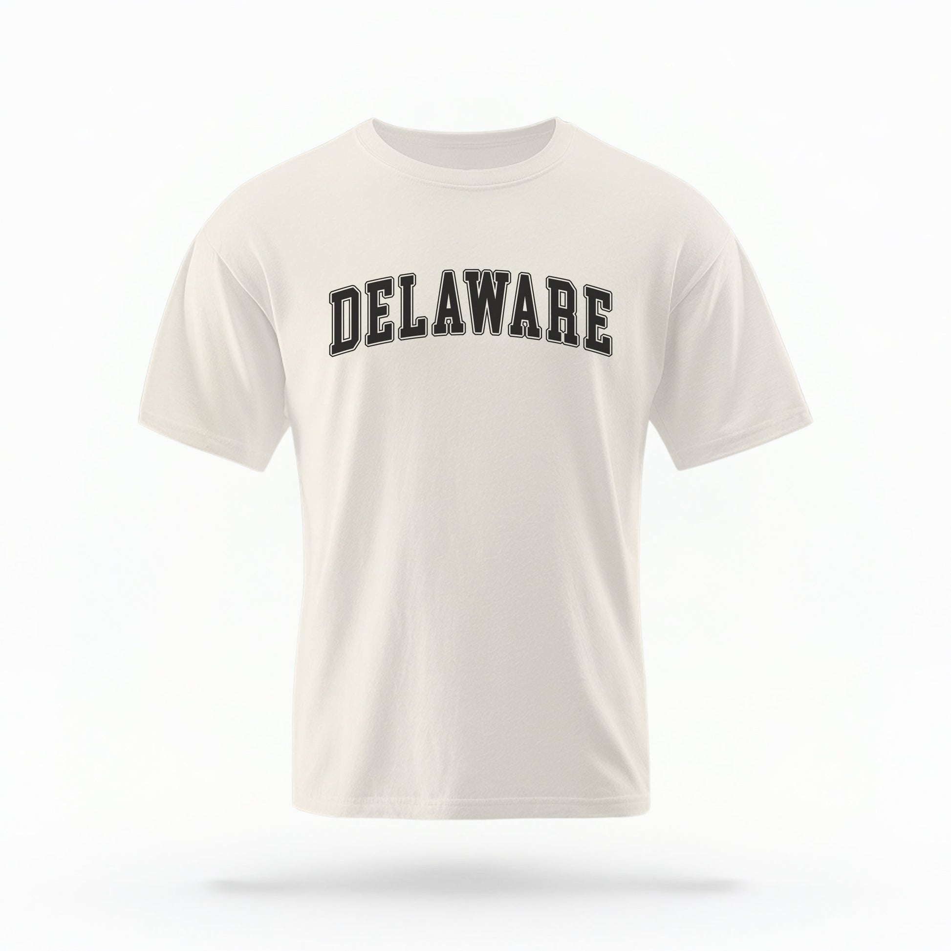 The ivory Unisex Delaware Varsity Comfort Colors T-shirt lays flat on a white background. The Delaware graphic is in bold black in a varsity offset style.