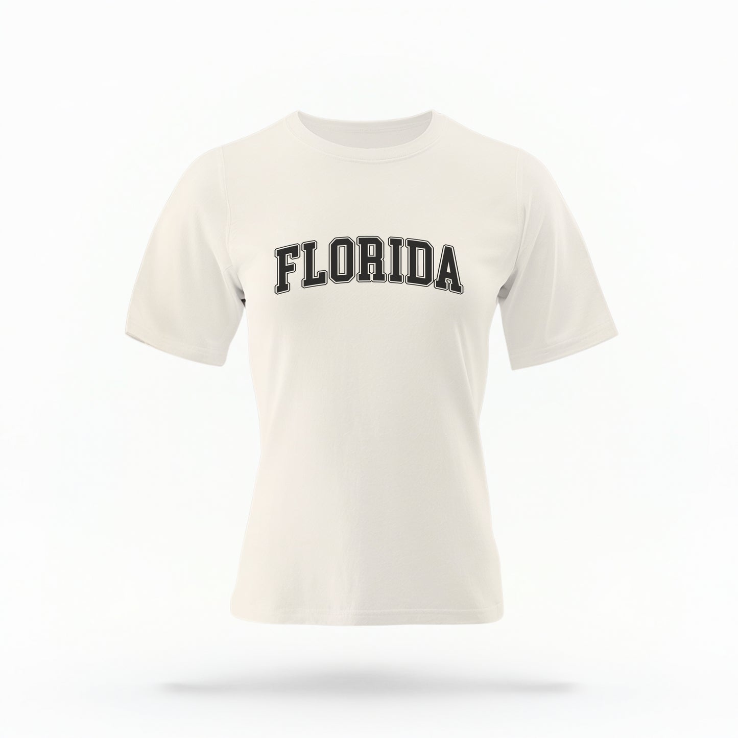The ivory Adult Unisex Florida Varsity Comfort Colors T-shirt lays flat on a white background. The Florida graphic is in bold white in a varsity offset style.
