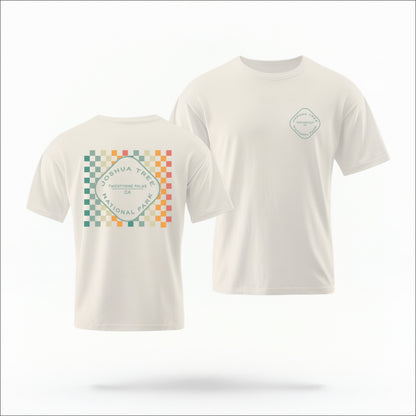 The Ivory Joshua Tree Retro Checkered Comfort Colors T-shirt lays flat on a white background. The ﻿Joshua Tree Retro Checkered﻿ graphic is in bold Multicolor in a Retro style.
