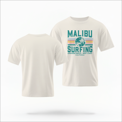 The Ivory Adult Unisex Malibu California Surfing Comfort Colors T-shirt lays flat on a white background. The ﻿Malibu California Surfing﻿ graphic is in bold Lifestyle in a Multicolor style.
