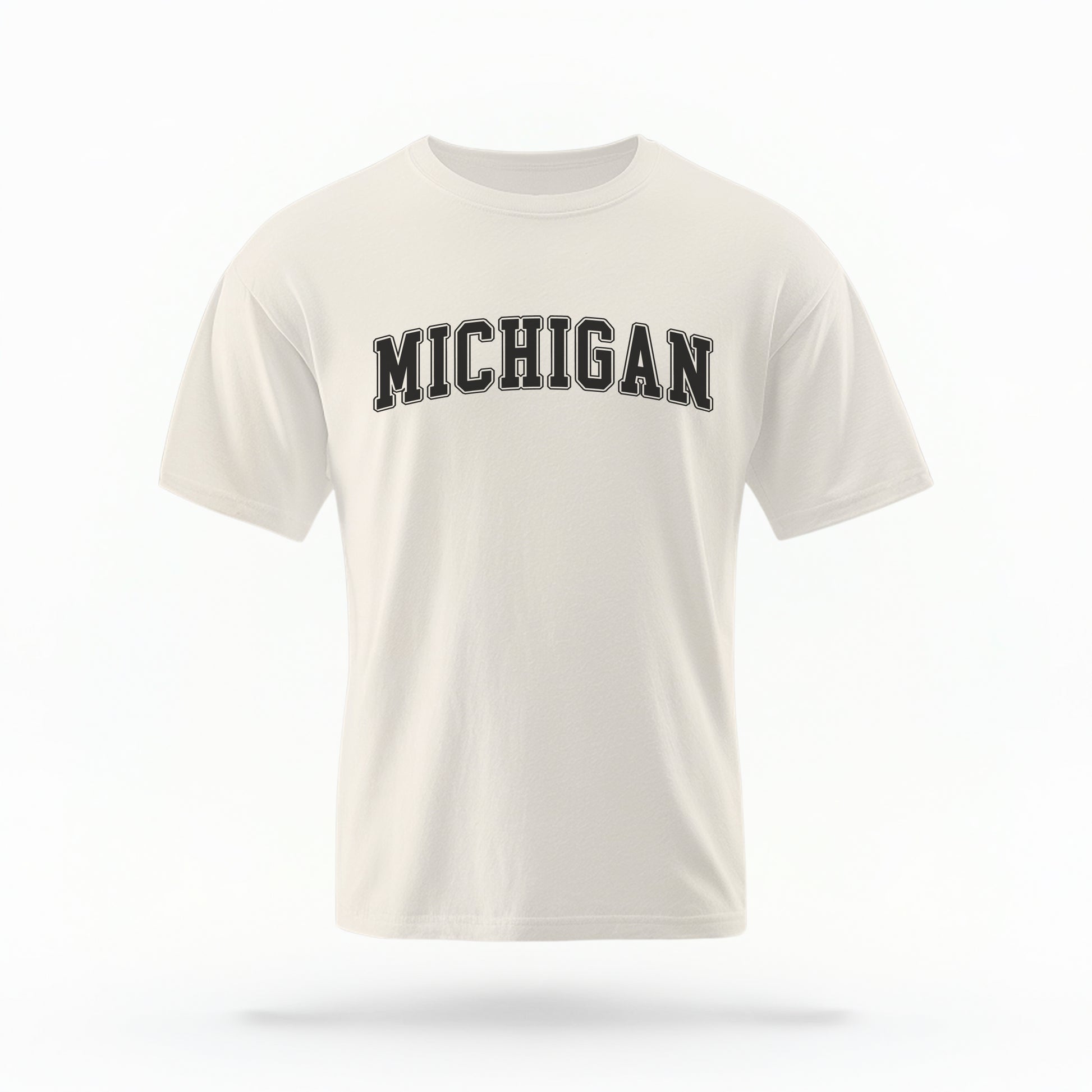 The ivory Unisex Michigan Varsity Comfort Colors T-shirt lays flat on a white background. The Michigan graphic is in bold black in a varsity offset style.