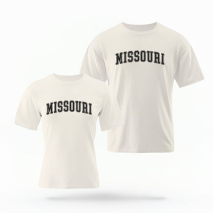 The ivory Unisex Missouri Varsity Comfort Colors T-shirt lays flat on a white background. The Missouri graphic is in bold black in a varsity offset style.