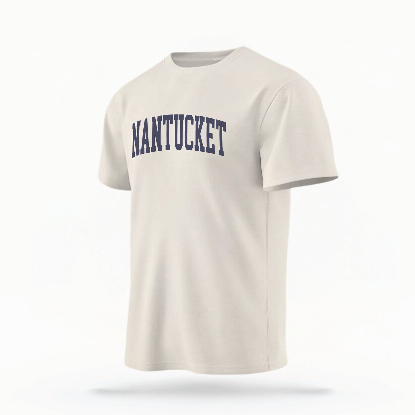 The ivory Unisex Nantucket Varsity Comfort Colors T-shirt lays flat on a white background. The Nantucket graphic is in bold navy in a varsity offset style.