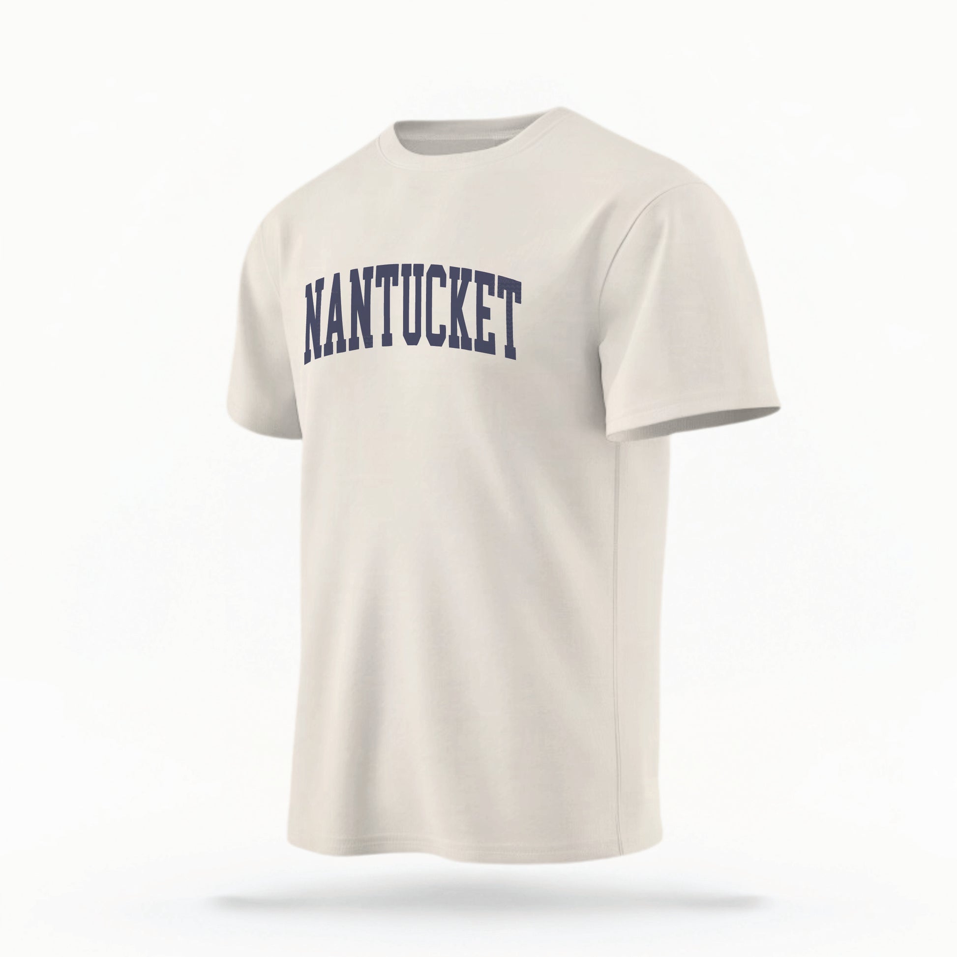 The ivory Unisex Nantucket Varsity Comfort Colors T-shirt lays flat on a white background. The Nantucket graphic is in bold navy in a varsity offset style.