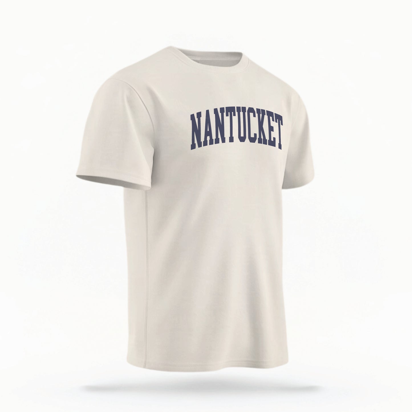 The ivory Unisex Nantucket Varsity Comfort Colors T-shirt lays flat on a white background. The Nantucket graphic is in bold navy in a varsity offset style.