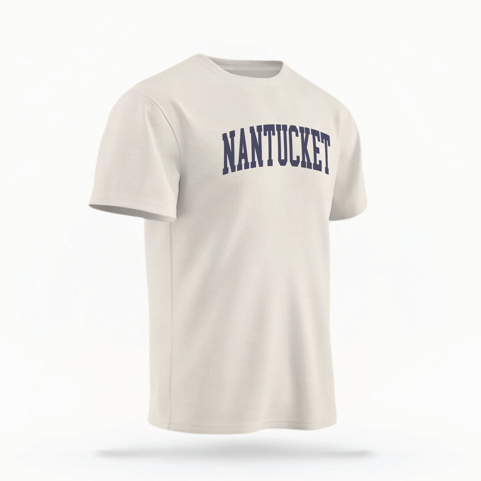 The ivory Unisex Nantucket Varsity Comfort Colors T-shirt lays flat on a white background. The Nantucket graphic is in bold navy in a varsity offset style.