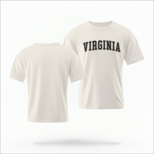 The ivory Unisex Virginia Varsity Comfort Colors T-shirt lays flat on a white background. The Virginia graphic is in bold black in a varsity offset style.