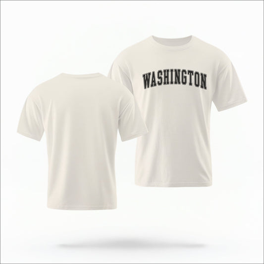 The ivory Unisex Washington Varsity Comfort Colors T-shirt lays flat on a white background. The Washington graphic is in bold black in a varsity offset style.