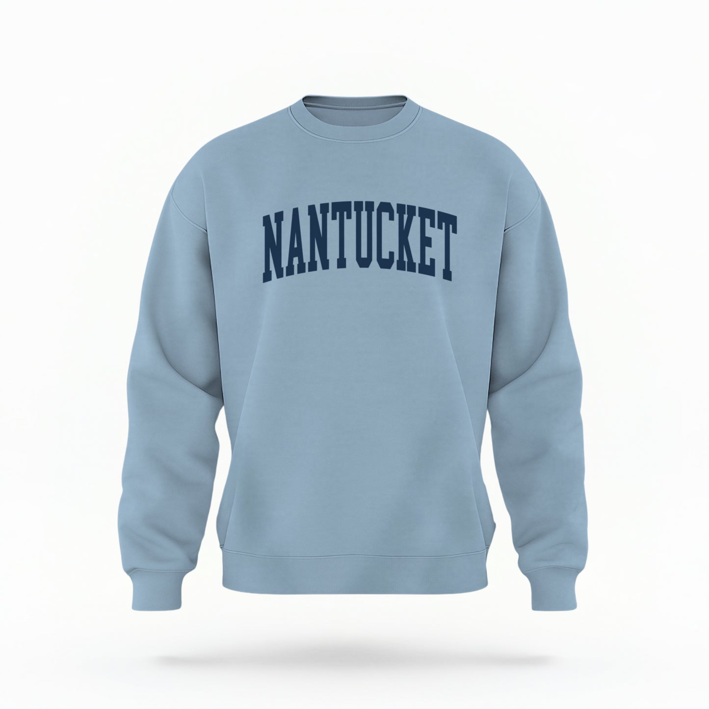 The Light Blue Unisex Nantucket Varsity Crewneck Sweatshirt lays flat on a white background. The Nantucket graphic is in bold navy and varsity offset style.