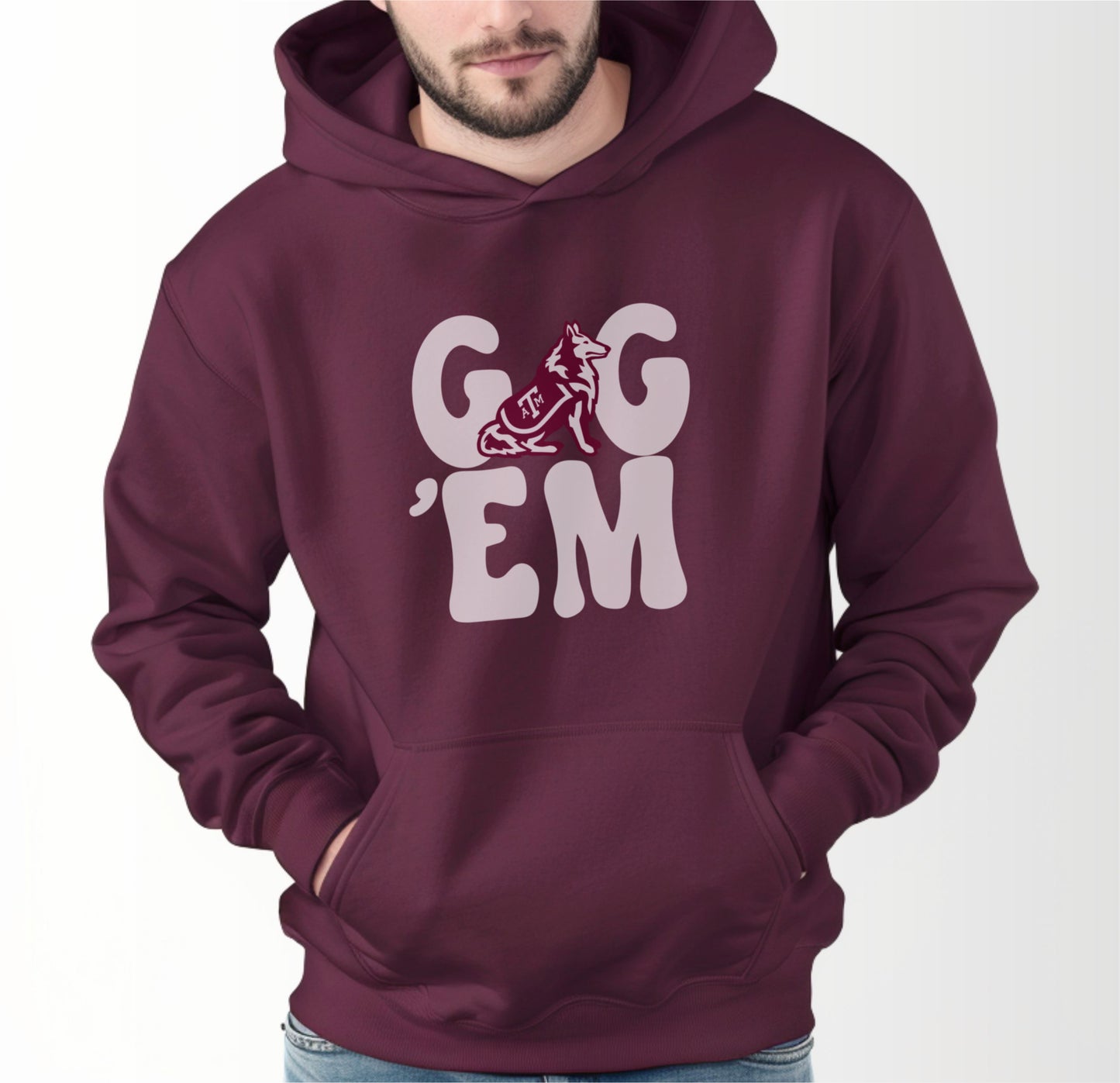 A model wears the Maroon Adult Unisex Texas A&M Gig 'Em Retro Reveille Hooded Sweatshirt.  The ﻿Texas A&M Gig 'Em Retro Reveille﻿ graphic is in bold White in a Groovy Vintage style.