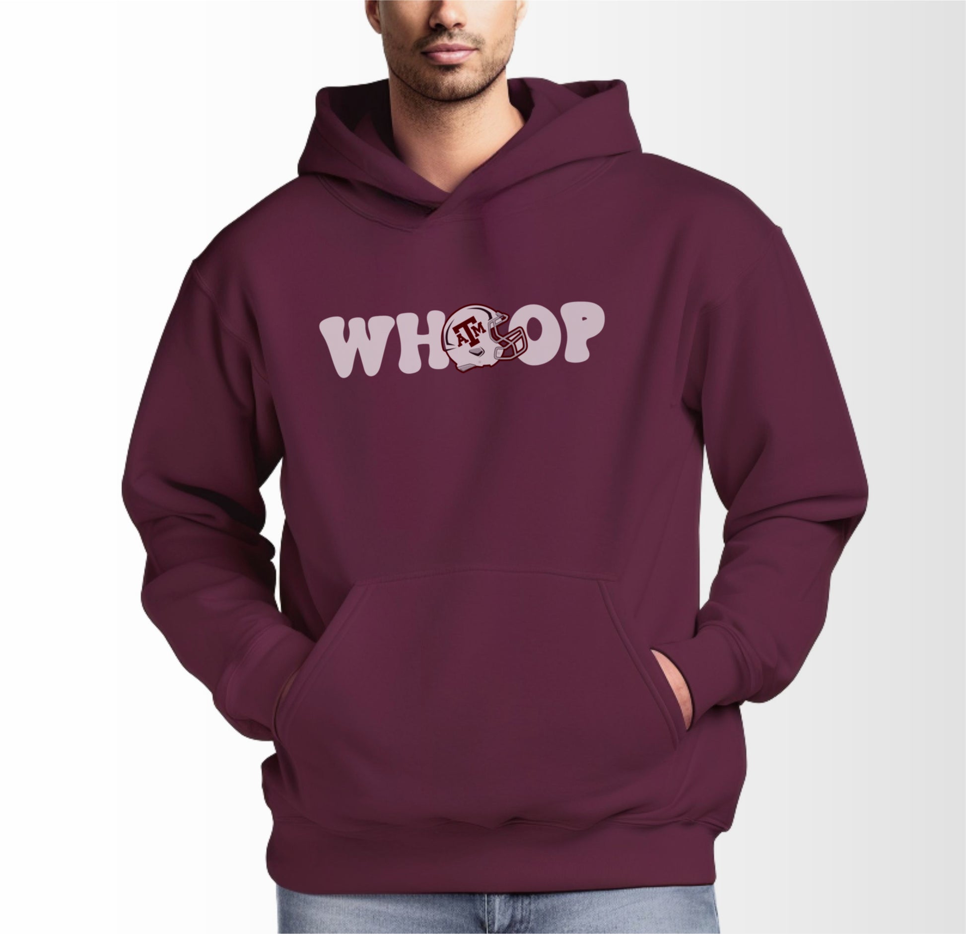 A model wears the Maroon Adult Unisex Texas A&M Retro Whoop Hooded Sweatshirt.  The ﻿Texas A&M Retro Whoop﻿ graphic is in bold White in a Vintage style.