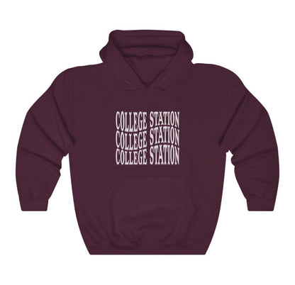 The Maroon Adult Unisex College Station Western Hooded Sweatshirt lays flat on a white background. The ﻿College Station Western﻿ graphic is in bold White in a Western style.