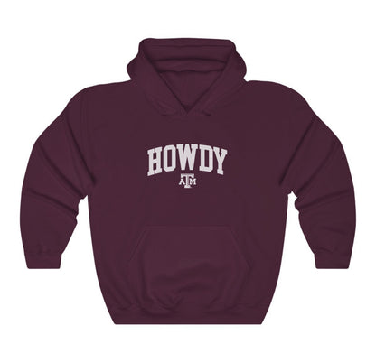 The Maroon Adult Unisex Texas A&M Howdy Varsity Hooded Sweatshirt lays flat on a white background. The ﻿Texas A&M Howdy Varsity﻿ graphic is in bold White in a Collegiate style.