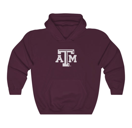 The Maroon Adult Unisex Texas A&M Logo Hooded Sweatshirt lays flat on a white background. The ﻿Texas A&M Logo﻿ graphic is in bold White in a Varsity style.