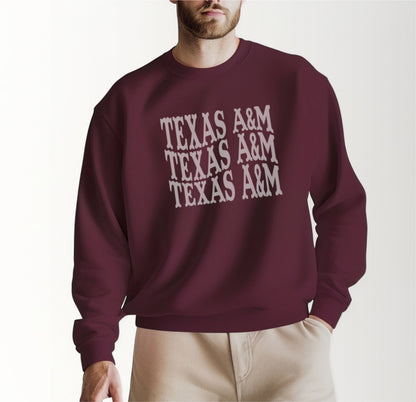 A model wears the Maroon Adult Unisex Texas A&M Western Crewneck Sweatshirt.  The ﻿Texas A&M Western﻿ graphic is in bold White in a Western style.