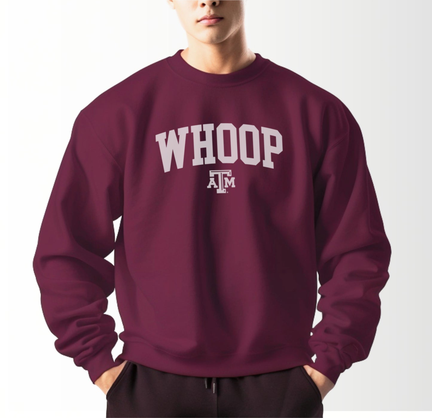 A model wears the Maroon Adult Unisex Texas A&M Whoop Collegiate Crewneck Sweatshirt.  The ﻿Texas A&M Whoop Collegiate﻿ graphic is in bold White in a Varsity style.