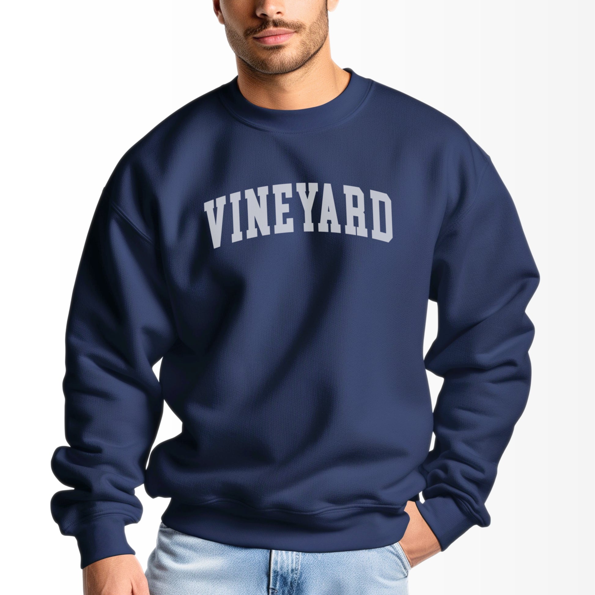 A model wears the Navy Adult Unisex Martha's Vineyard Massachusetts Classic Crewneck Sweatshirt.  The ﻿Martha's Vineyard Massachusetts Classic﻿ graphic is in bold White in a Varsity style.