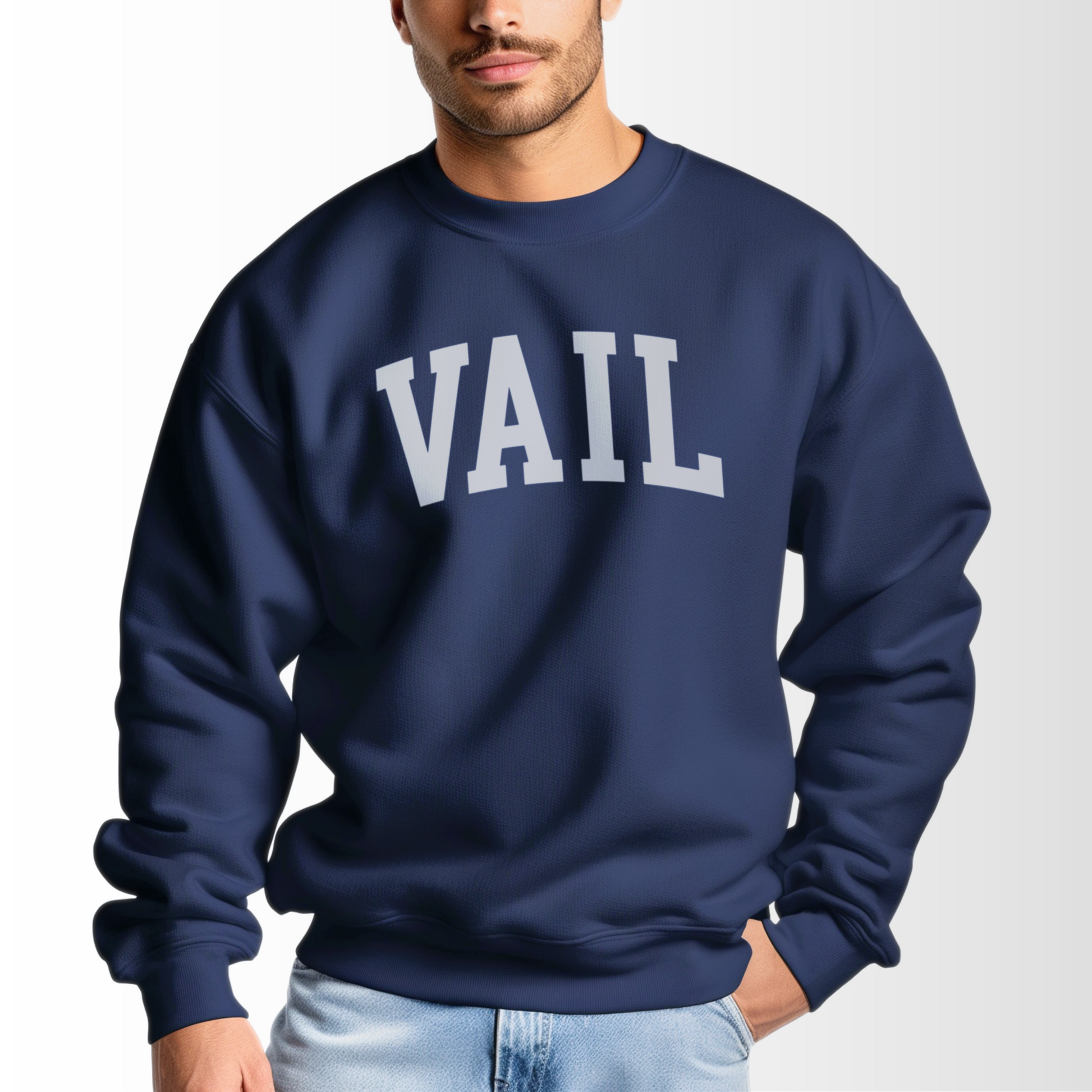 A model wears the Navy Vail Colorado Varsity Crewneck Sweatshirt.  The ﻿Vail Colorado Varsity﻿ graphic is in bold White in a Collegiate style.