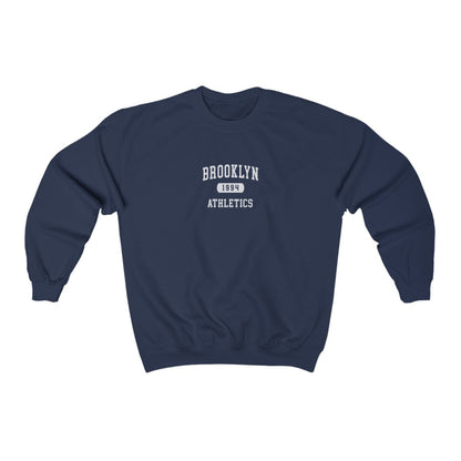 The Navy Brooklyn Athletics Crewneck Sweatshirt lays flat on a white background. The ﻿Brooklyn Athletics﻿ graphic is in bold Black in a Varsity style.