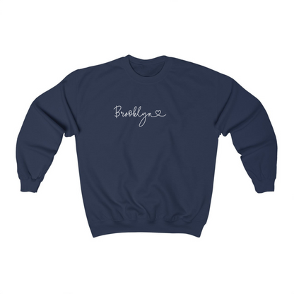 The Navy Adult Unisex Brooklyn NY Dainty Crewneck Sweatshirt lays flat on a white background. The ﻿Brooklyn NY Dainty﻿ graphic is in bold White in a Script style.