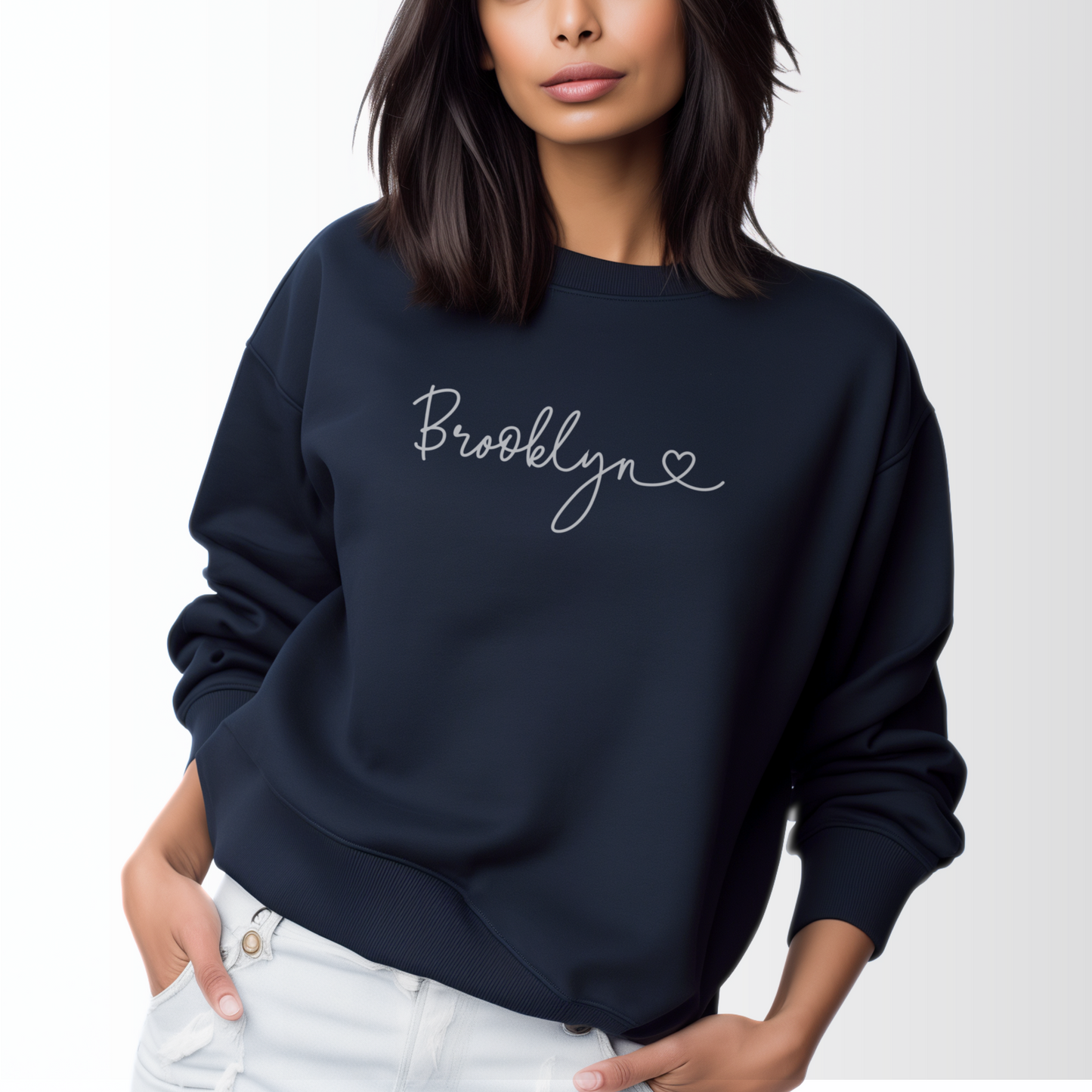 A model wears the Navy Adult Unisex Brooklyn NY Dainty Crewneck Sweatshirt.  The ﻿Brooklyn NY Dainty﻿ graphic is in bold White in a Script style.