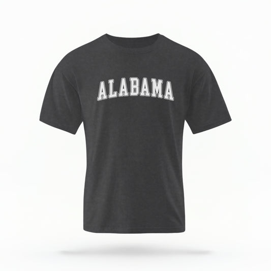 The Pepper Unisex Alabama Varsity Comfort Colors T-shirt lays flat on a white background. The Alabama graphic is in bold white in a varsity offset style.