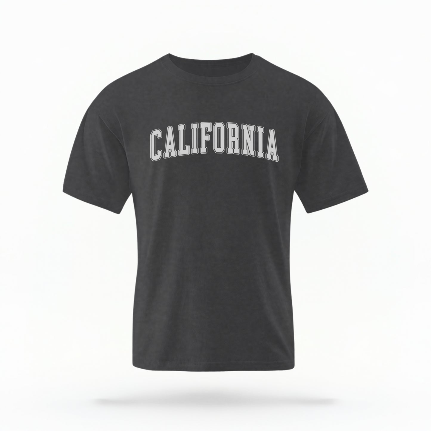 The Pepper California Varsity Comfort Colors T-shirt lays flat on a white background. The ﻿California Varsity﻿ graphic is in bold White in a Varsity style.