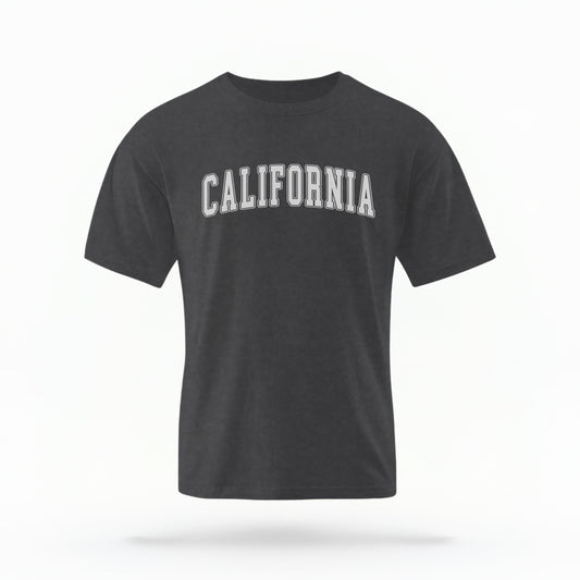 The Pepper California Varsity Comfort Colors T-shirt lays flat on a white background. The ﻿California Varsity﻿ graphic is in bold White in a Varsity style.